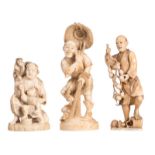 Three Japanese ivory okimono depicting a fisherman, a peasant and a father and child