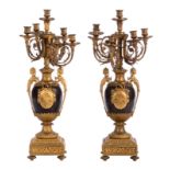 A neoclassical pair of candelabra, bronze / brass and ebonised metal, late 19thC, H 75 cm