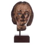 An 18thC head in sculpted and polychromed wood, glass eyes, possibly Southern Europe, H 20 (