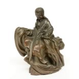 A Chinese bronze Guanyin sitting on a rock, 19thC, H 16 cm