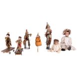 Lot of seven dolls: polichinelle, paper-maché, original clothing, about 1880; towing vehicle, head