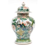 A Chinese famille verte stoneware vase with cover, marked, 19thC, H 48 cm (wooden base included)