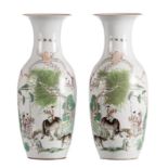 A pair of Chinese polychrome decorated vases with figures and a water buffalo in a landscape, H 58