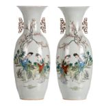 A pair of Chinese polychrome decorated vases with court ladies and children in a garden and