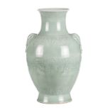 A Chinese celadon and floral relief decorated baluster shaped vase, the handles elephant's head