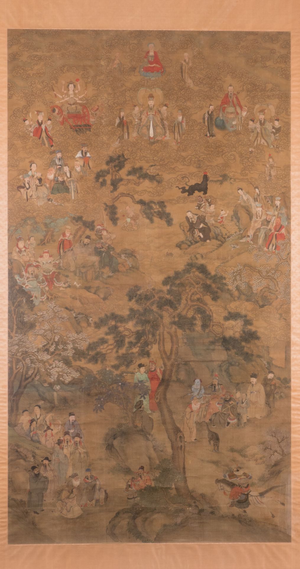 A Chinese scroll, textile on paper, silk mount, depicting Buddhist and Taoist Gods and Goddesses,