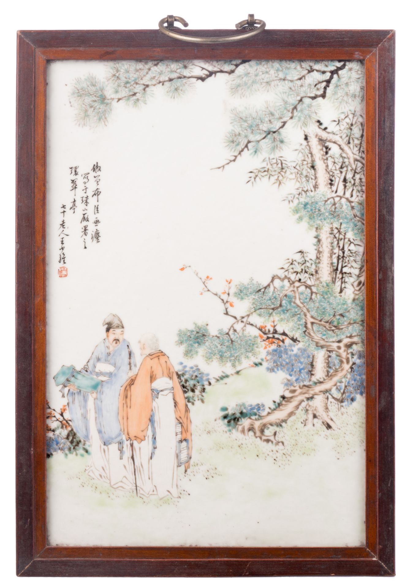 A Chinese polychrome decorated plaque with two figures in a landscape, with calligraphic texts,