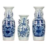 A pair of Chinese celadon ground blue and white vases decorated with flower branches; added a