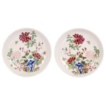 A pair of Chinese polychrome decorated dishes with a rock, flower branches and butterflies, with a