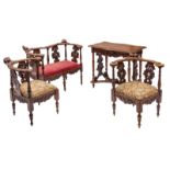 A Historism Italian Baroque revival walnut small sofa, two corner chairs and a table, H 80 - W