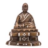 A Chinese bronze and silver plated bronze seated Buddha, H 7 - W 6 cm