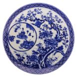 A Japanese blue and white decorated plate with birds and flower branches, the medallion with an