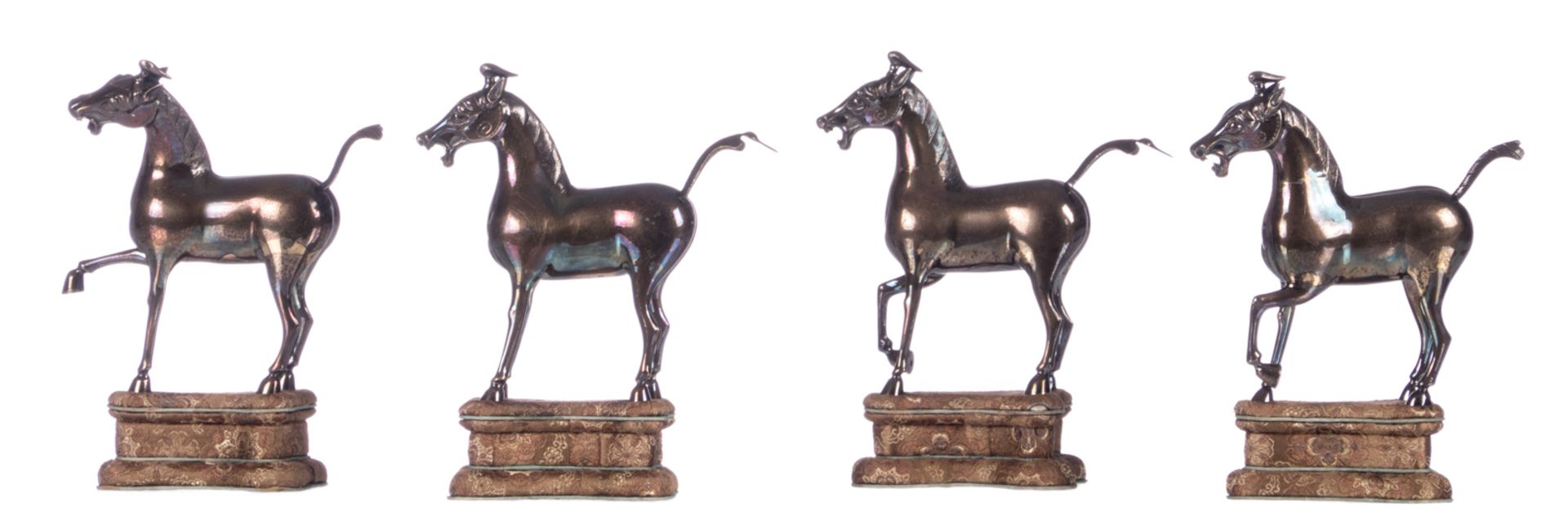 Four Chinese sterling silver horses, standing on a textile covered base, 20thC, H horses 11,4 - H