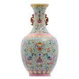 A Chinese turquoise ground famille rose vase, floral decorated with mythological animals and symbols