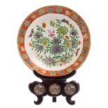 A Chinese polychrome decorated plate with flower branches, fish and butterflies, 18thC, on a