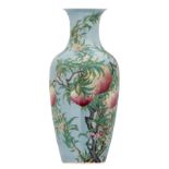 A Chinese light blue ground famille rose decorated vase with peaches and blossoms, H 46 cm