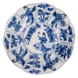 A Chinese blue and white decorated lobed plate with figures and flower branches, marked, 17thC, H