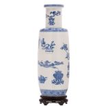 A Chinese blue and white decorated rouleau shaped vase with antiquities and flower branches, on a