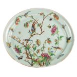 A Chinese oval celadon ground famille rose decorated plate with birds on flower branches and