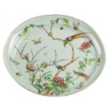 A Chinese oval celadon ground famille rose decorated plate with birds on flower branches and