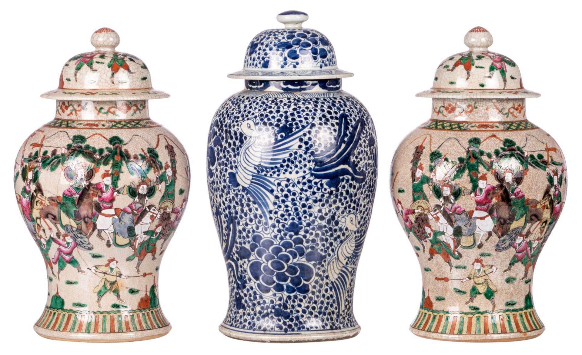 A pair of Chinese stoneware vases and covers, overall polychrome decorated with warrior scenes,