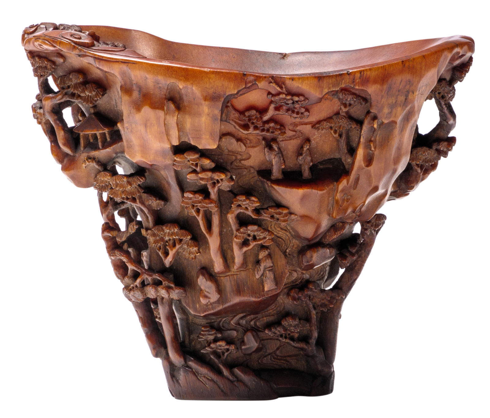 An extraordinary finely carved rhinoceros horn libation cup, the flaring sides finely carved in