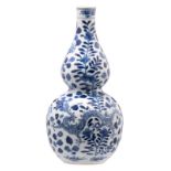 A Chinese blue and white decorated double gourd vase with dragons and flower branches, H 33,5 cm