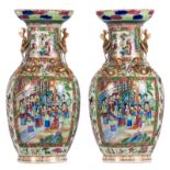 A pair of Chinese famille rose vases, floral and relief decorated, the roundels with court and