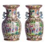 A pair of Chinese famille rose floral decorated Canton vases, the roundels depicting the Eight