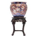 A large Japanese Imari ribbed jardiniere, Edo, on a matching Oriental carved wooden base with marble