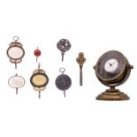 A presumably French 18thC watch in a watch holder; added a collection of pocket watch keys decorated