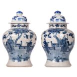 A pair of Chinese blue and white decorated stoneware vases with figures in a landscape, Kangxi