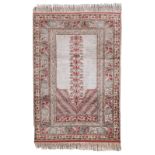 An Oriental silk prayer rug, decorated with floral motifs, 89 x 134 cm