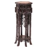 A Chinese hexagonal richly carved hardwood stand with marble top, H 84 - ø 34 cm