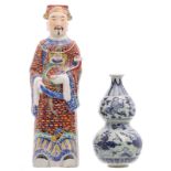 A Chinese polychrome decorated figure depicting Lu Xing, marked; added a Chinese celadon fond blue