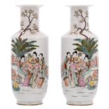 A pair of Chinese polychrome decorated rouleau shaped vases with a garden scene and calligraphic
