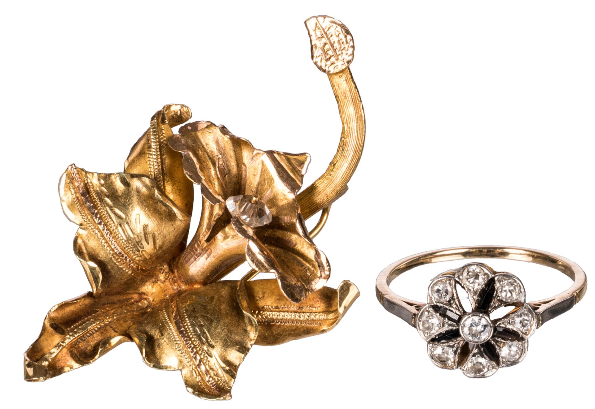 An 18ct golden orchid shaped brooch set with (zircon); added an 18ct gold ladies ring set with