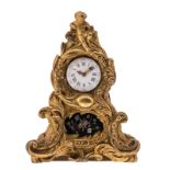 A probably French and 18thC Rococo style table clock, gilt bronze and a tole plate with mother of