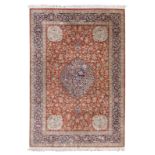 An Oriental silk rug, floral decorated, the roundels with birds on flower branches, marked, 202 x