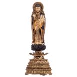 A Japanese gilt lacquered carved standing wooden Buddha on a ditto lotus base, Meiji and period, H