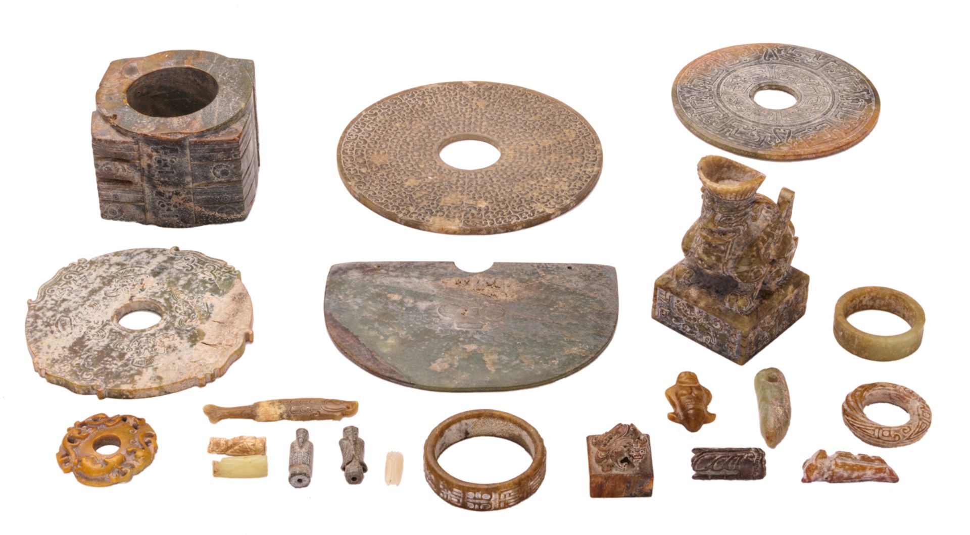 An important collection of Chinese carved jade ceremonial and ritual items: various bi disks,