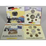 Zwei Kursmünzsätze, 50 Jahre BRD und 50 Jahre Deutsche Mark, in der Original-Verpackung