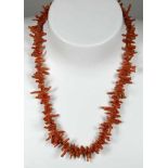 Korallen-Halskette, gefertigt aus unregelmäßig geformten Stücken, Farbe: orange-rot, goldfarbene