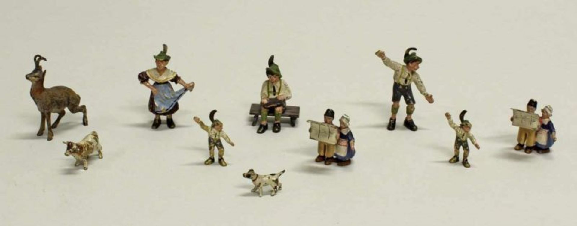 10 Miniaturfiguren, "Trachtenfiguren und Tiere", Wiener Bronze, polychrom, 1-4 cm hoch, Farbverluste