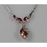 Collier, WG 585, 4 Rubin-Navettes, 2 runde facettierte Rubine, 8 Brillanten zus. ca. 0.50 ct.,