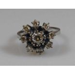 Ring, WG 585, 1 Brillant ca. 0.20 ct., 8 Besatz-Brillanten, 8 facettierte Saphire, 5 g, RM 17.5 20.