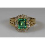 Ring, GG 750, 1 Smaragd ca. 1.30 ct., im Baguetteschliff, 14 Altschliff-Diamanten zus. ca. 0.70 ct.,