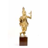 Krishna auf Holzsockel Südindien, um 1920, Bronze, mit Goldfarbe staffiert, Höhe 86 cm, Finger einer