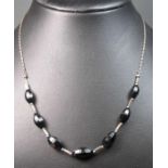 COLLIER / KETTE / necklace, 925er Silber mit Onyx-Anteilen im facettierten Olivenschliff. L. 45 cm.