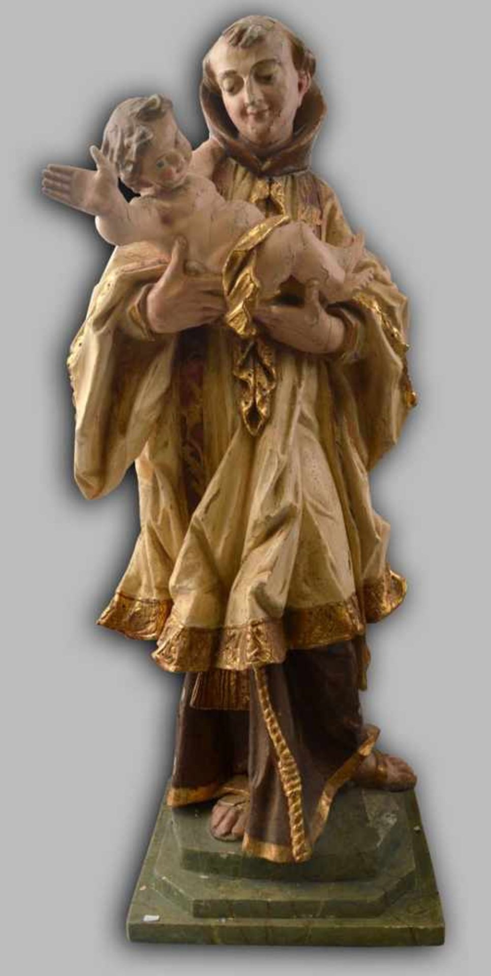 Heiliger Antonius mit Kind Hartholz, auf rechteckigem Sockel stehend, faltenreiches Gewand, beige/